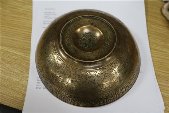 An Islamic bronze magic bowl with incised Koranic inscriptions within geometric motifs, Dia 7.5in (wear to interior)